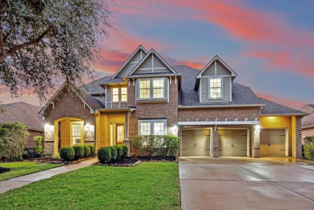 view of front of house with a garage and a lawn