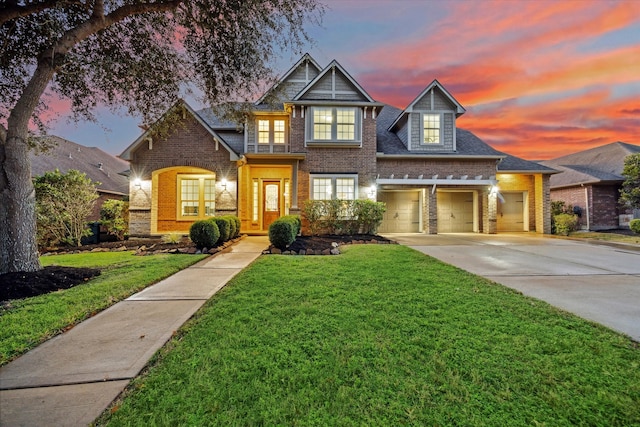 view of front of property with a garage and a yard