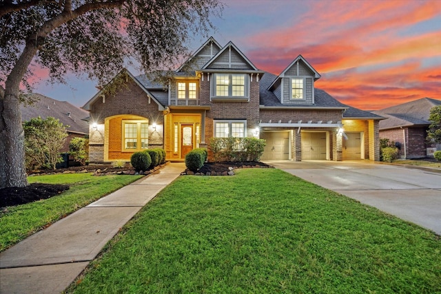 view of front of house featuring a garage and a lawn