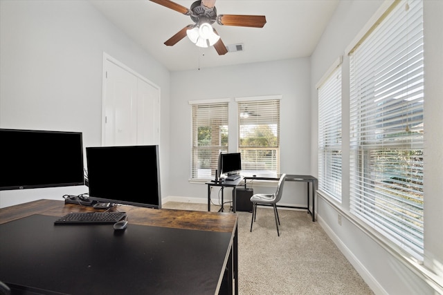 office area featuring light carpet and ceiling fan