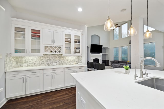 kitchen featuring white cabinetry, sink, decorative light fixtures, and dark hardwood / wood-style floors