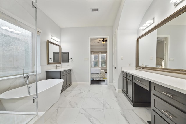 bathroom featuring a tub, ceiling fan, and vanity