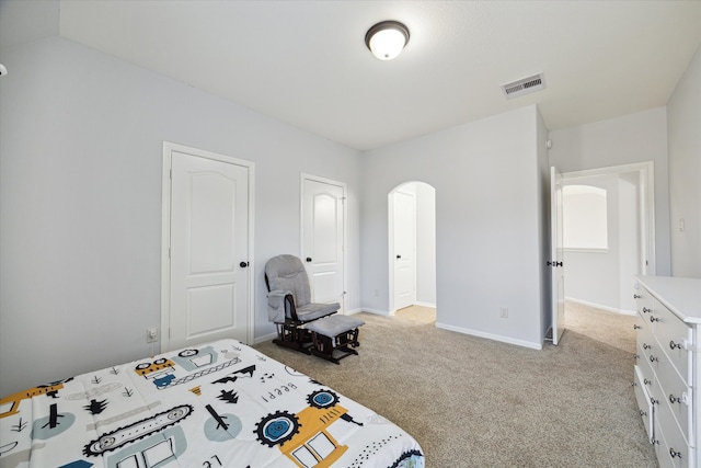 bedroom featuring light colored carpet