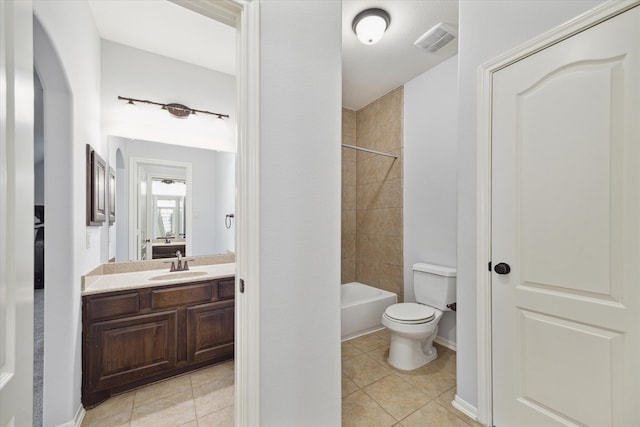 full bathroom with vanity, tile patterned flooring, toilet, and tiled shower / bath combo