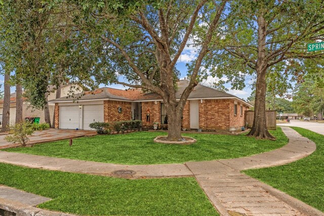 single story home with a garage and a front yard