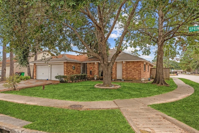 view of front of property with a garage, brick siding, concrete driveway, and a front yard