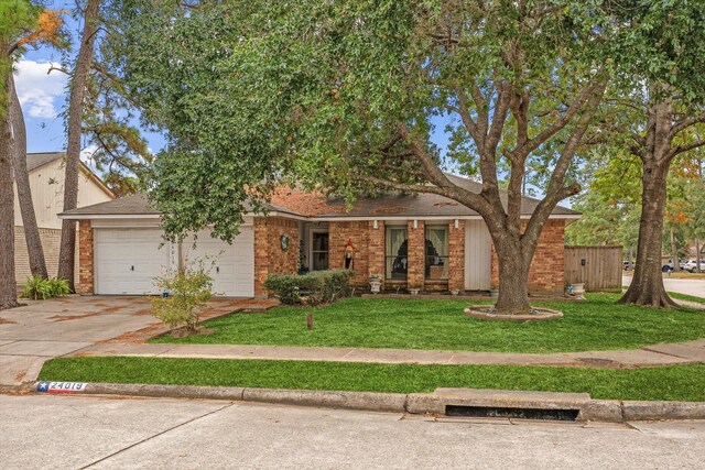 view of front of home featuring a garage and a front lawn