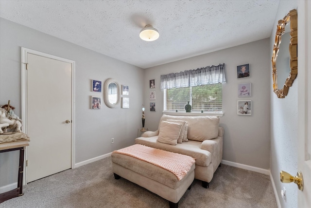 bedroom featuring a textured ceiling, baseboards, and carpet floors