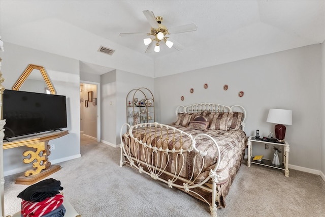 carpeted bedroom with visible vents, baseboards, ceiling fan, and vaulted ceiling