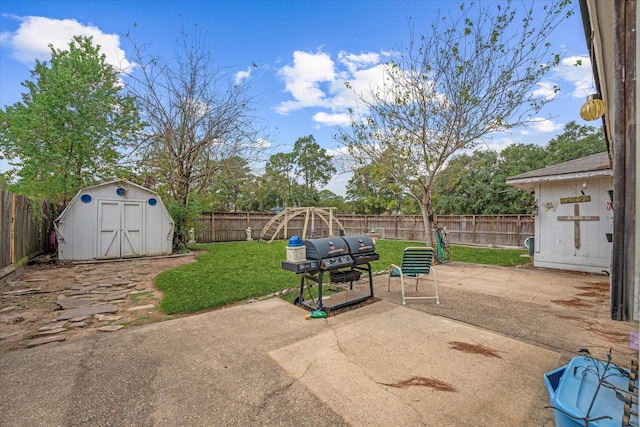 view of patio / terrace featuring grilling area, a fenced backyard, a storage shed, and an outdoor structure