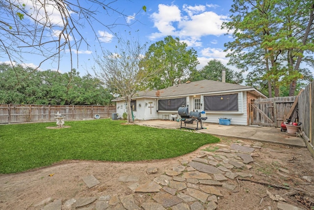 back of property with a gate, a lawn, a fenced backyard, and a patio area