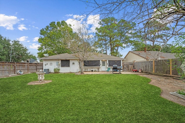 rear view of property featuring a patio area, central air condition unit, a lawn, and a fenced backyard