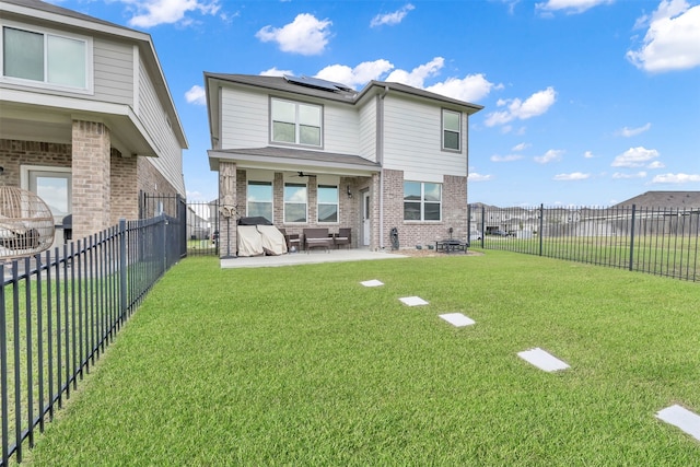 back of house featuring a yard and a patio area