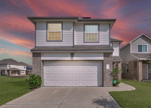 view of property with a garage and a yard