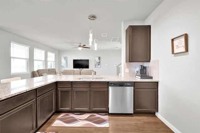 kitchen featuring dishwasher, sink, ceiling fan, light wood-type flooring, and decorative light fixtures