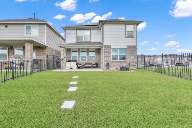 back of property with a yard and a patio area