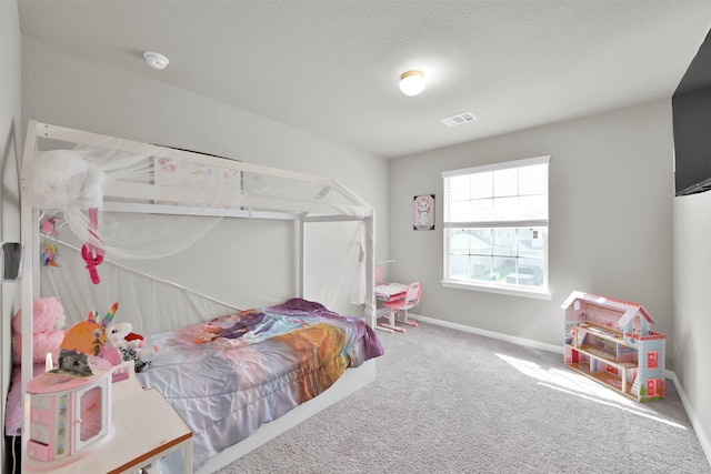 carpeted bedroom featuring a textured ceiling