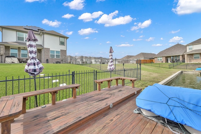 wooden deck featuring a lawn