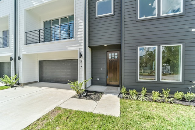 view of front of home with a balcony and a garage