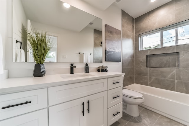 full bathroom with vanity, toilet, and tiled shower / bath combo