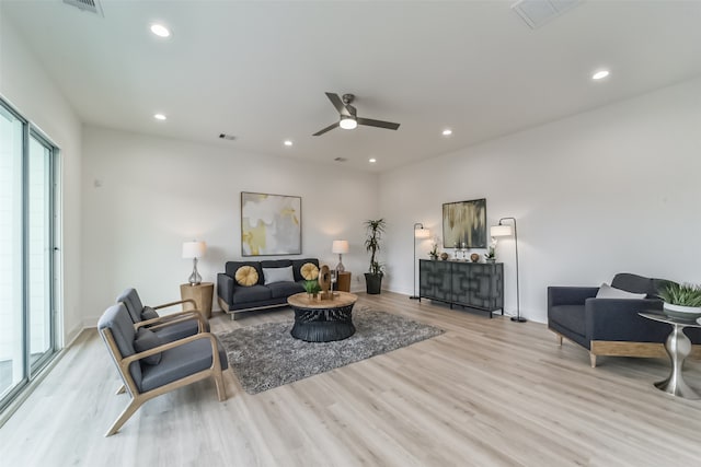 living room featuring ceiling fan and light hardwood / wood-style floors