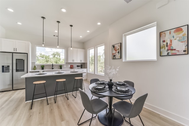 dining space with light hardwood / wood-style flooring