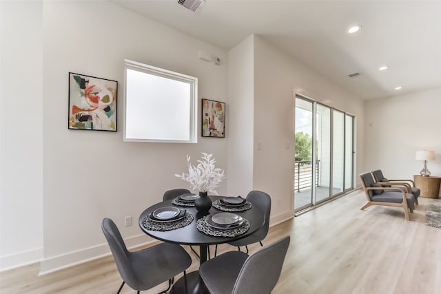 dining space with light hardwood / wood-style floors