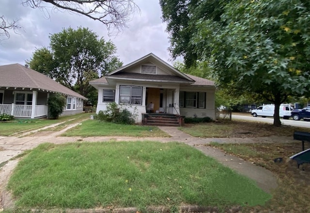 bungalow-style house featuring a front yard