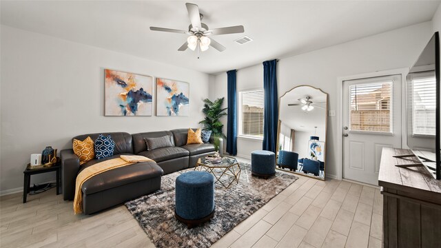 living room with light wood-type flooring and ceiling fan