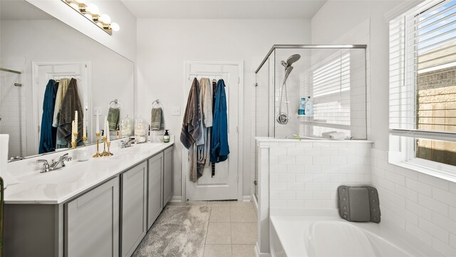 bathroom featuring independent shower and bath, vanity, and tile patterned floors