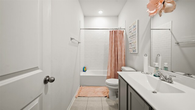 full bathroom featuring vanity, shower / bath combo with shower curtain, tile patterned flooring, and toilet