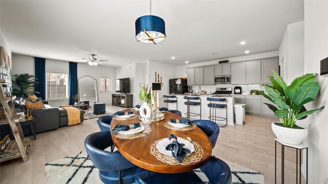 dining area featuring light hardwood / wood-style flooring and ceiling fan