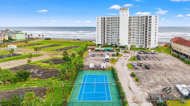 drone / aerial view featuring a water view and a beach view