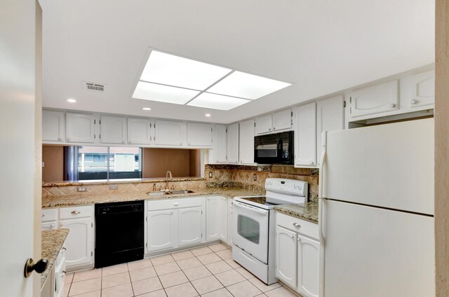 kitchen featuring decorative backsplash, sink, black appliances, white cabinetry, and light tile patterned flooring