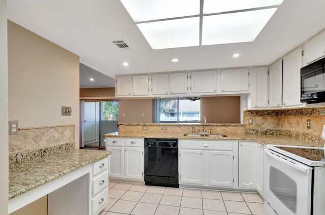 kitchen featuring light tile patterned floors, sink, white cabinetry, and black appliances