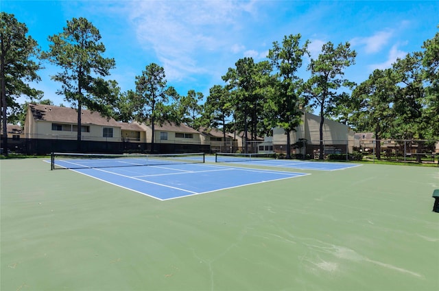 view of tennis court featuring basketball hoop