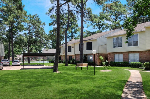 surrounding community featuring a yard and a carport