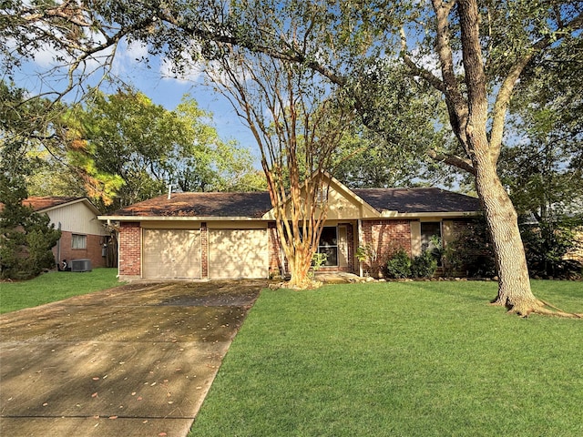 ranch-style home with a garage, cooling unit, and a front yard