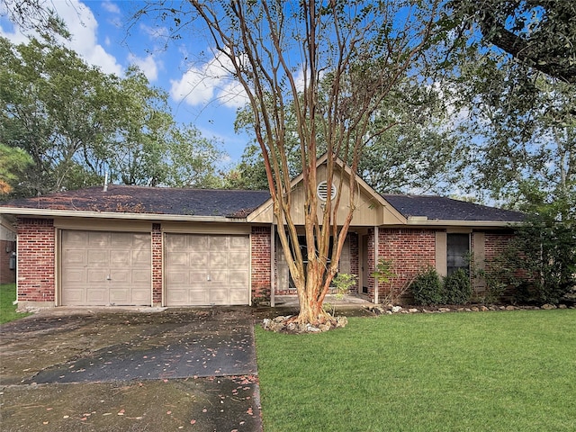 ranch-style house featuring a garage and a front yard