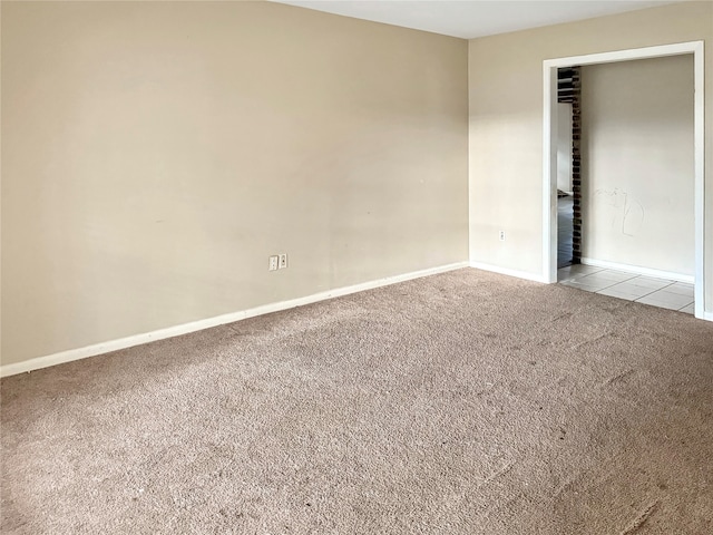 spare room featuring light carpet