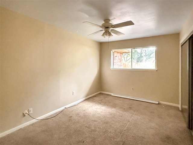 unfurnished room featuring ceiling fan, baseboard heating, and carpet