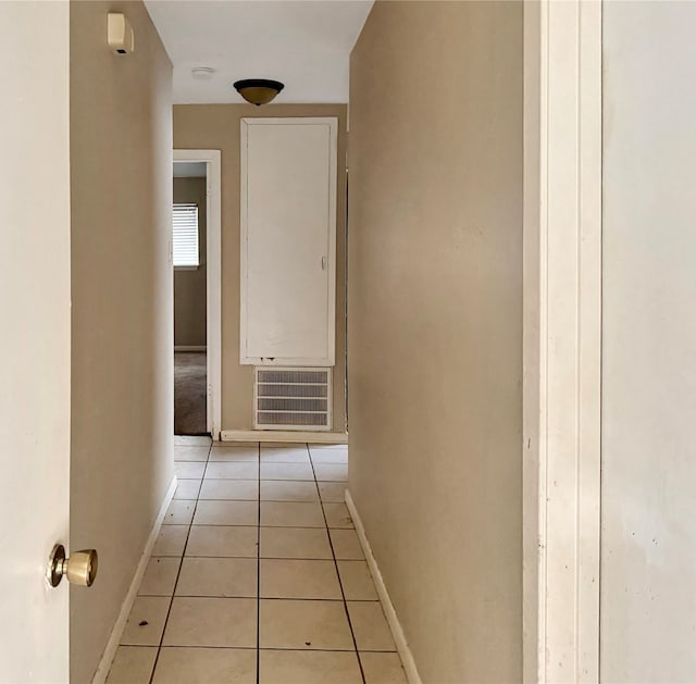 corridor featuring light tile patterned floors