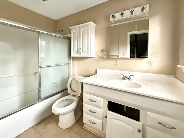 full bathroom featuring bath / shower combo with glass door, tile patterned flooring, vanity, and toilet