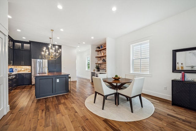 dining room featuring dark wood-type flooring and an inviting chandelier