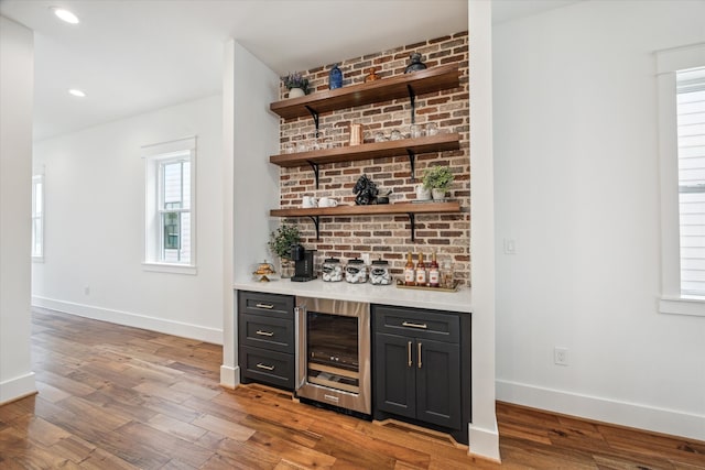 bar featuring hardwood / wood-style floors and plenty of natural light