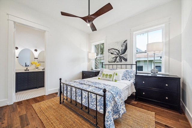 bedroom with ceiling fan, sink, and dark hardwood / wood-style flooring