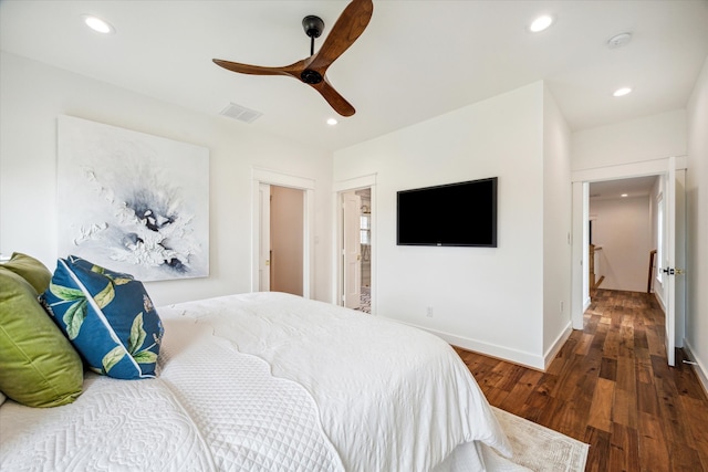 bedroom with ceiling fan, ensuite bath, and dark hardwood / wood-style flooring