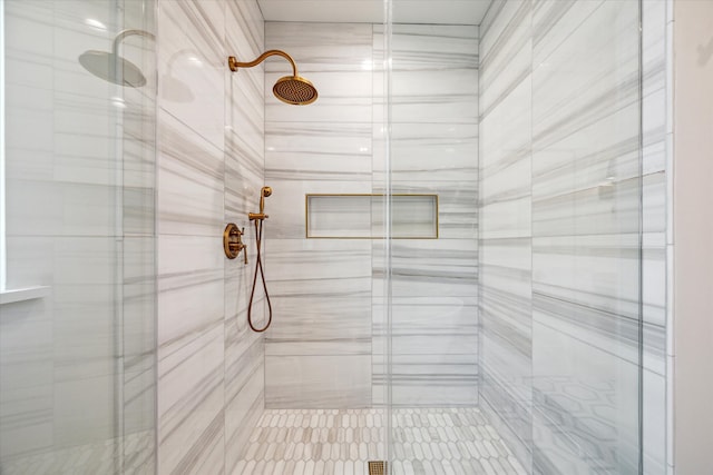 bathroom featuring a shower with shower door