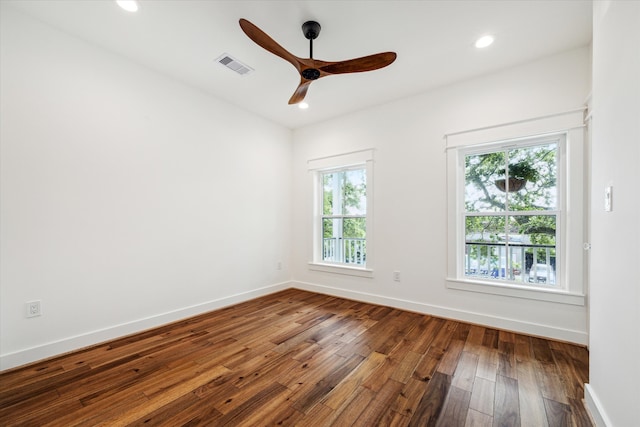 unfurnished room with ceiling fan, hardwood / wood-style flooring, and a healthy amount of sunlight