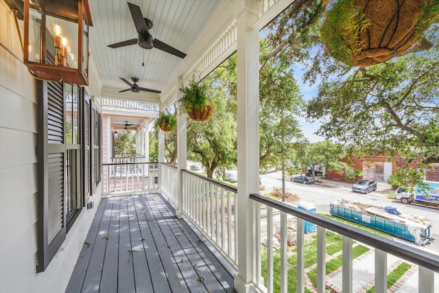 deck with ceiling fan and covered porch